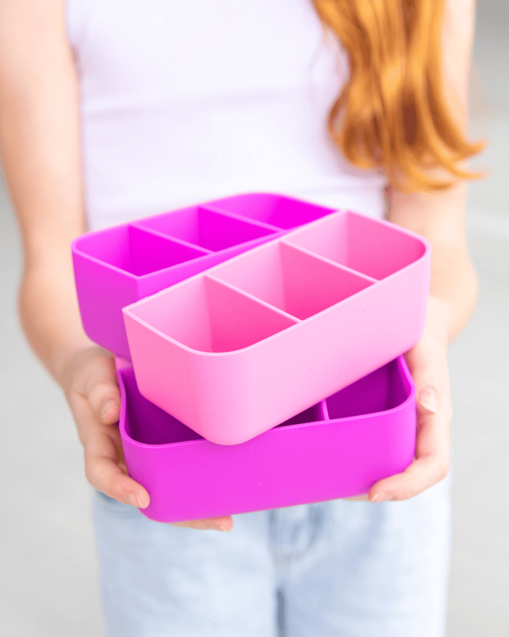 MontiiCo Bite Tray - child holding different color of bite tray
