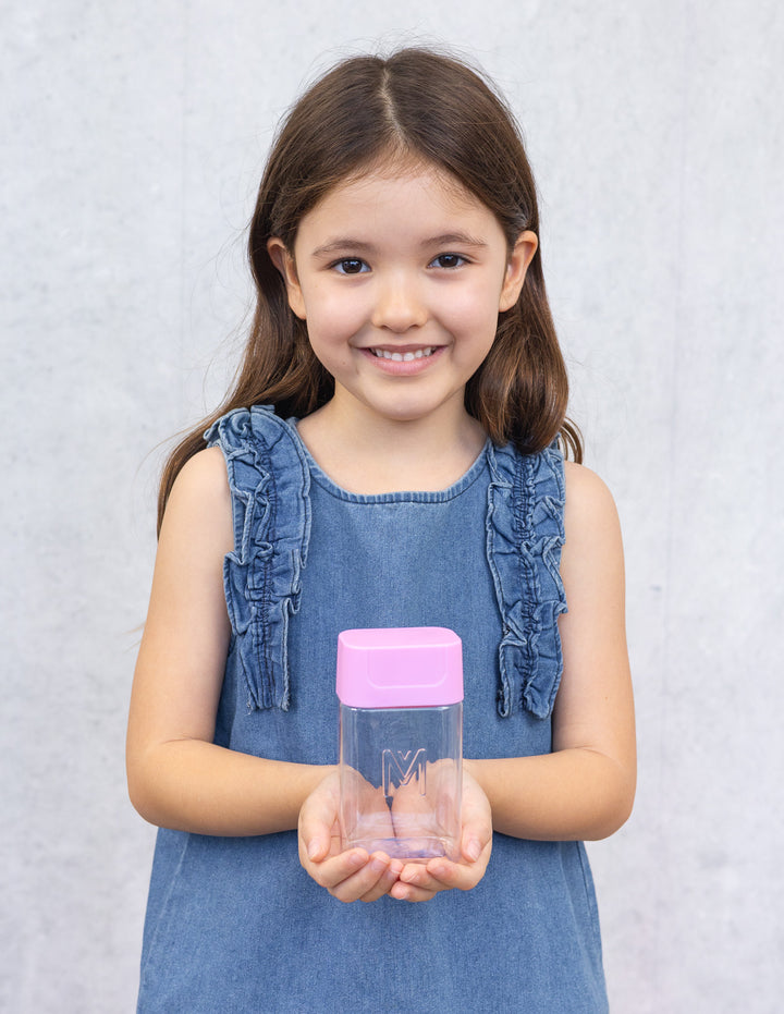 MontiiCo Bento Bottle - Floss child holding the bottle