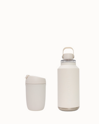 Two beige insulated bottles on a white background
