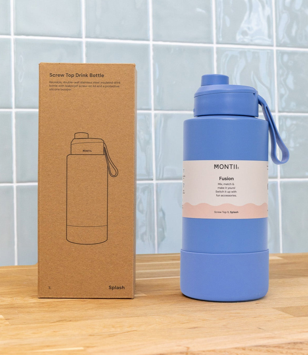 Blue water bottle with Montil branding on a wooden surface against a tiled wall background