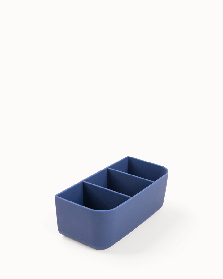 Blue rectangular silicone container with compartments on a white background