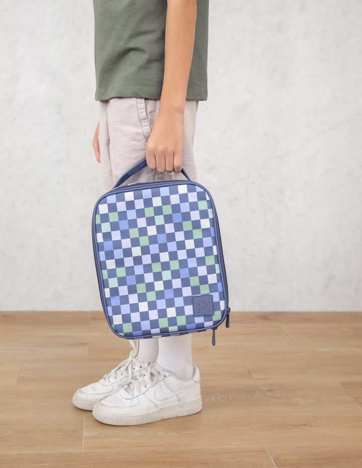 Person holding a blue and green checkered bag