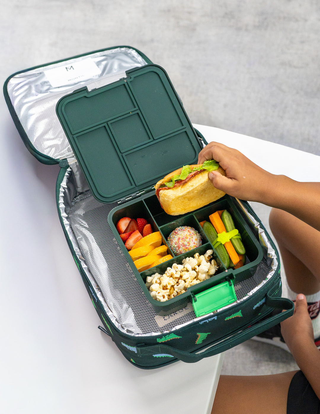 MontiiCo Bento Five - Dinosaur filled with fruit and snacks