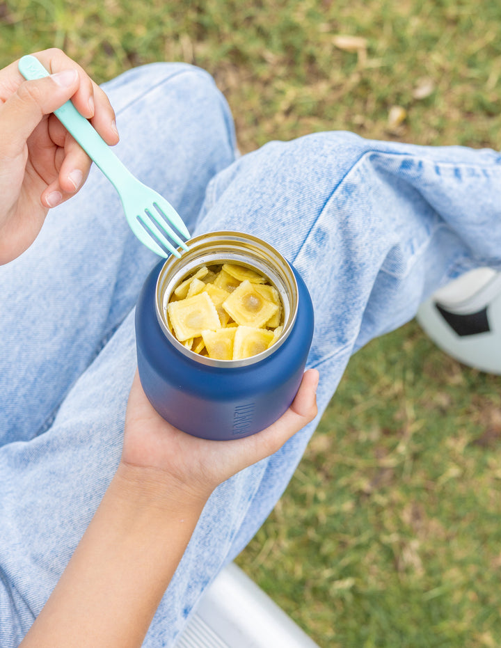 Child holding thermos lunch pot for school lunch