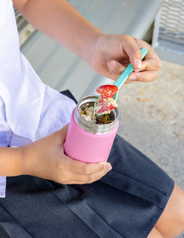 Child holding thermos snack pot for school lunch