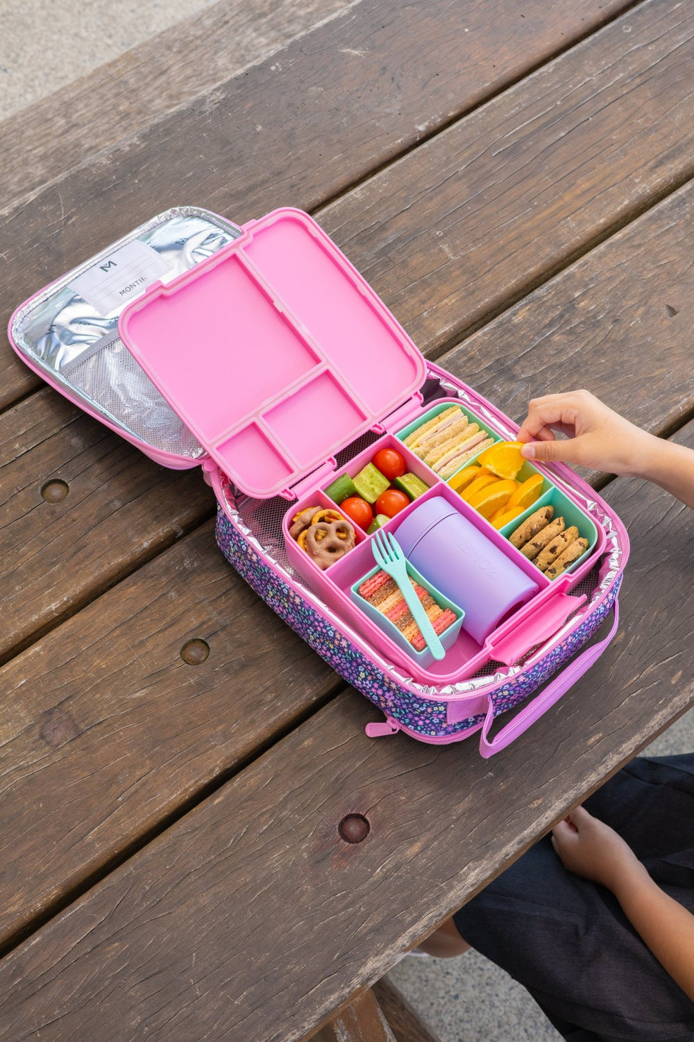 Insulated food thermos in lunchbox with fruit and snacks