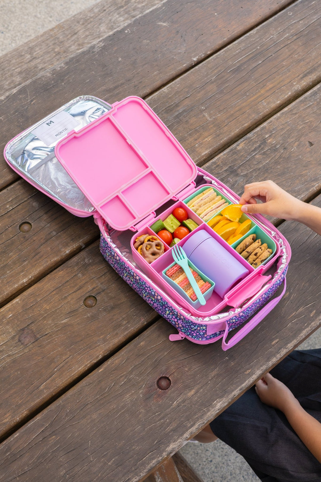 Insulated food thermos in lunchbox with fruit and snacks