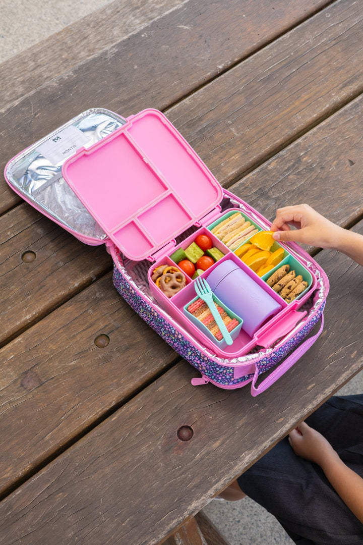 Insulated food thermos in lunchbox with fruit and snacks