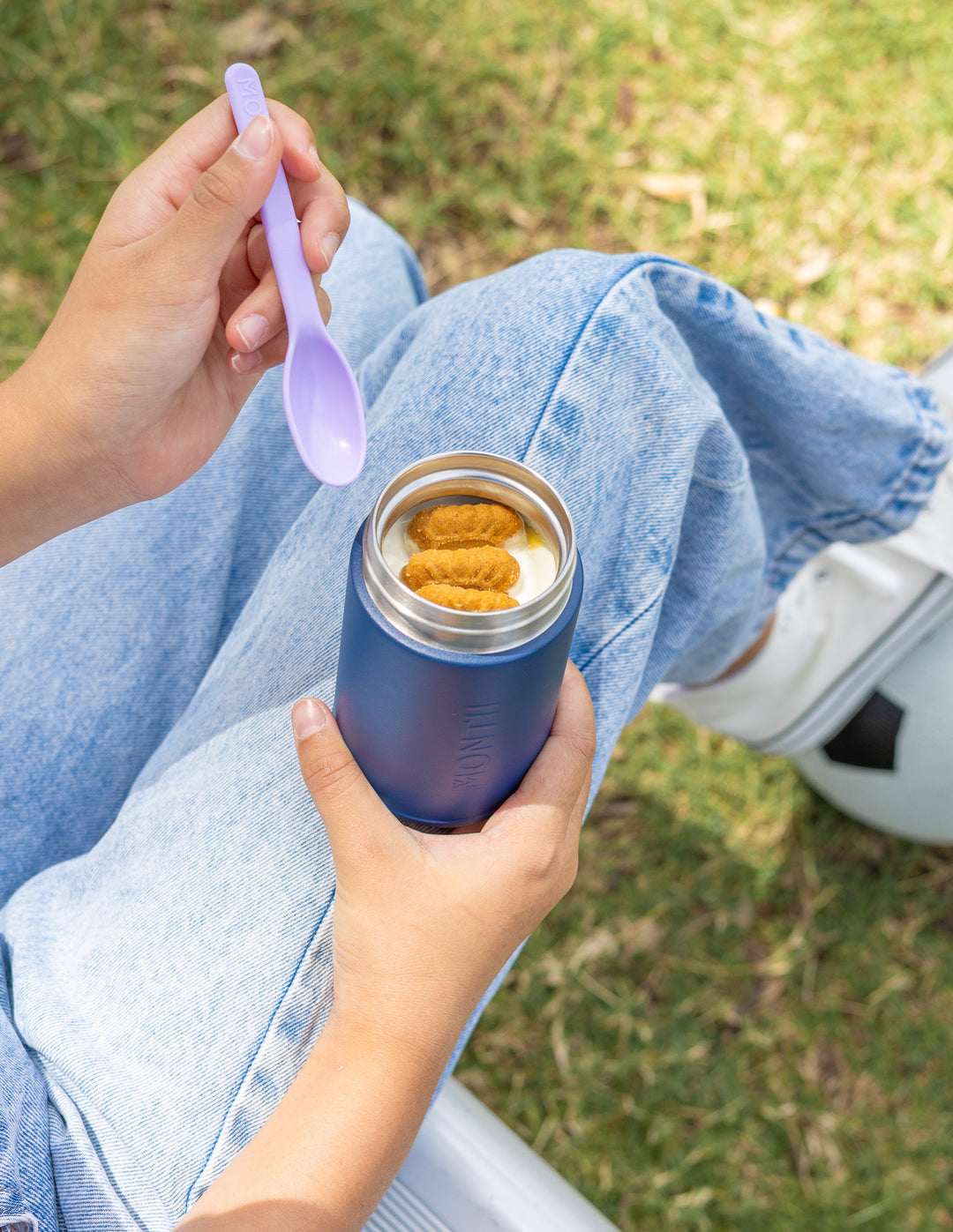 Child holding thermos snack pot for school lunch